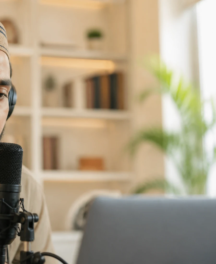 Editorial close-up of active Tajweed recitation with headphones and microphone — guided pronunciation practice.